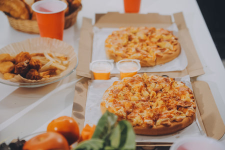 Group of young friends eating pizza.Home party.の写真素材
