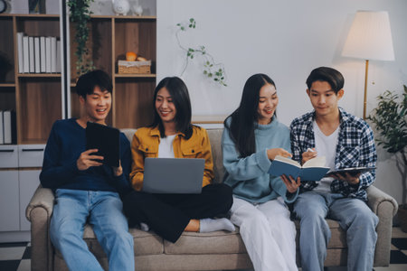 Young friends doing school assignment together at homeの写真素材
