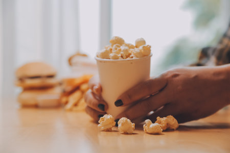 A woman holding a bowl of popcornの写真素材