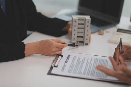 Sale representative offer house purchase contract to buy a house or apartment or discussing about loans and interest ratesの写真素材