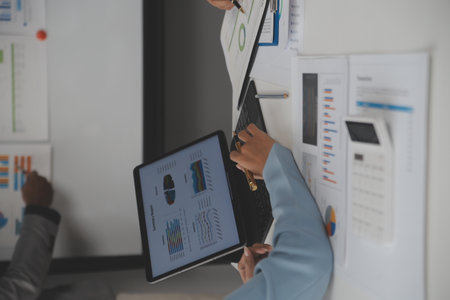 Close up of Business team analyzing income charts and graphs with modern laptop computer. Business analysis and strategy concept.の写真素材