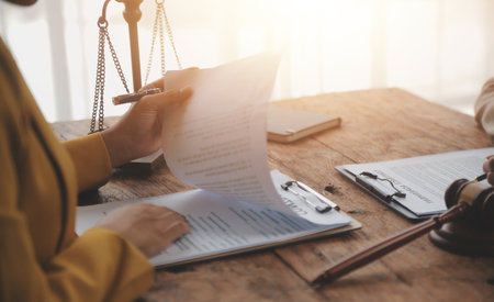 Business and lawyers discussing contract papers with brass scale on desk in office. Law, legal...