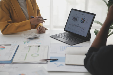 Close up of Business team analyzing income charts and graphs with modern laptop computer. Business...