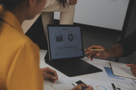 Close up of Business team analyzing income charts and graphs with modern laptop computer. Business analysis and strategy concept.の写真素材