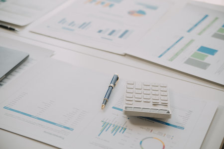 Financial analysts analyze business financial reports on a digital tablet planning investment...