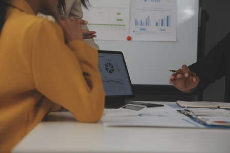 Close up of Business team analyzing income charts and graphs with modern laptop computer. Business analysis and strategy concept.の写真素材