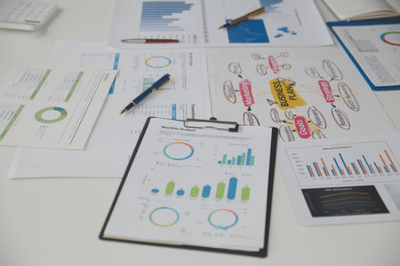 Close up of Business team analyzing income charts and graphs with modern laptop computer. Business...