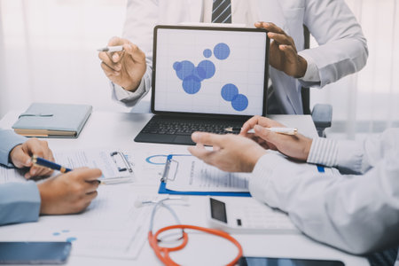 Meeting, tablet and team of doctors with collaboration for healthcare talk and telehealth app in office. Surgeon group, tech and medical discussion with website for hospital funding or sponsorshipの写真素材