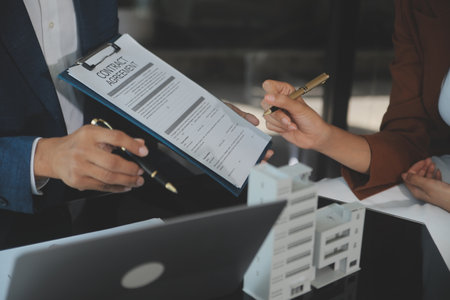 Real estate agent and customer signing contract to buy house, insurance or loan real estate.rent a house,get insurance or loan real estate or property.の写真素材