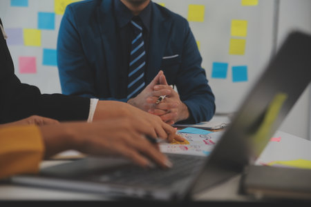 Meeting of business executives discussing analysis of the company's financial situation and business planning with partner collaboration and consultation of strategy.の写真素材