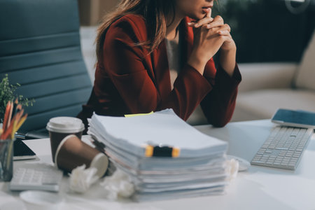 Young asian business woman with tired eyes and headacheの写真素材