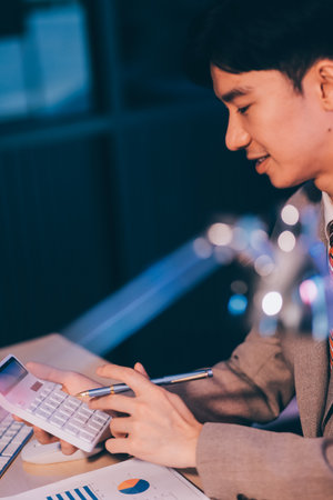Business accounting concept Businessman uses calculator with laptop computer Budget and borrowed...