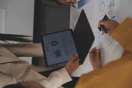 Close up of Business team analyzing income charts and graphs with modern laptop computer. Business...