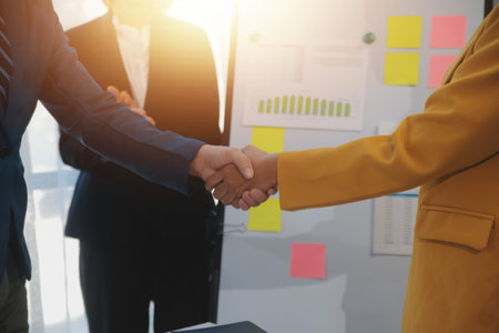 Hand shake business,Young business people shaking hands in the office. Finishing successful meeting....