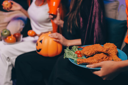 Joyful office Halloween party with coworkers in costumes, celebrating with drinks and laughter, fostering teamwork and festive spiritの写真素材
