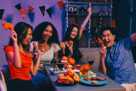 Joyful office Halloween party with coworkers in costumes, celebrating with drinks and laughter, fostering teamwork and festive spiritの写真素材