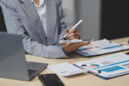 Business Documents, Auditor businesswoman checking searching document legal prepare paperwork or report for analysis TAX time,accountant Documents data contract partner deal in workplace officeの写真素材