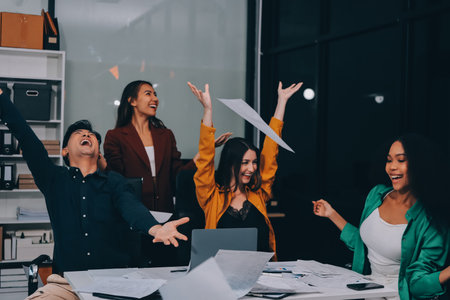 Motivated funny diverse business team people dancing celebrating success at corporate party on friday, happy friendly multiracial coworkers group having fun together enjoy victory dance in officeの写真素材