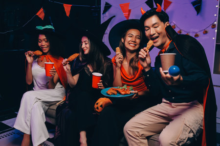 Joyful office Halloween party with coworkers in costumes, celebrating with drinks and laughter, fostering teamwork and festive spiritの写真素材