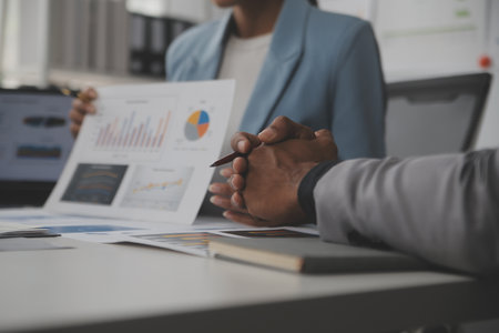 Close up of Business team analyzing income charts and graphs with modern laptop computer. Business analysis and strategy concept.の写真素材