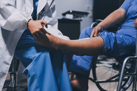 Physiotherapist nurse doing physiotherapy to rehabilitate leg of elderly female patient.