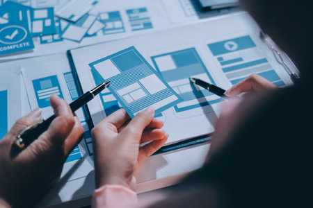 Young Asian business creative team work together, mobile application software design project. Brainstorm meeting, internet technology, smartphone web app designer, office coworker teamwork conceptの写真素材