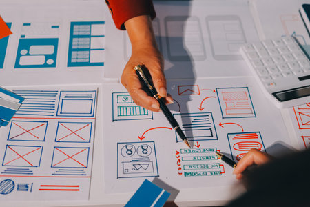 Young Asian business creative team work together, mobile application software design project....