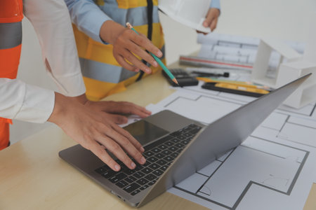 Construction and structure concept of Engineer or architect meeting for project working with partner and engineering tools on model building and blueprint in working site, contract for both companies.の写真素材