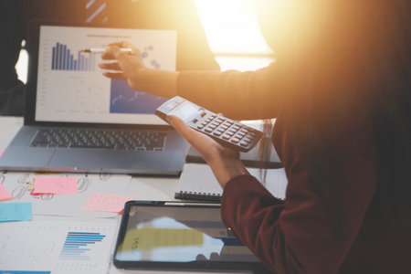 Meeting of business executives discussing analysis of the company's financial situation and business planning with partner collaboration and consultation of strategy.の写真素材