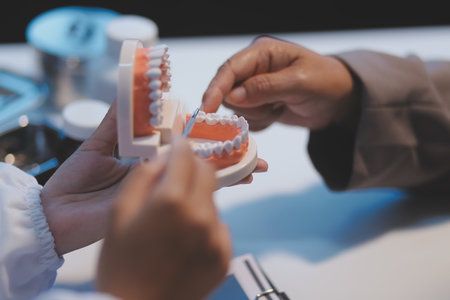 Dentist and patient discussion about planned dental treatment in dental clinic office, doctors talk...