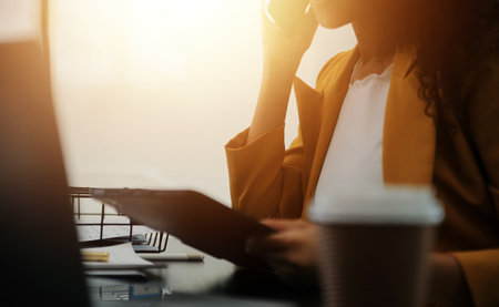 Close up Business woman using calculator and laptop for do math finance on wooden desk, tax, accounting, statistics and analytical research conceptの写真素材