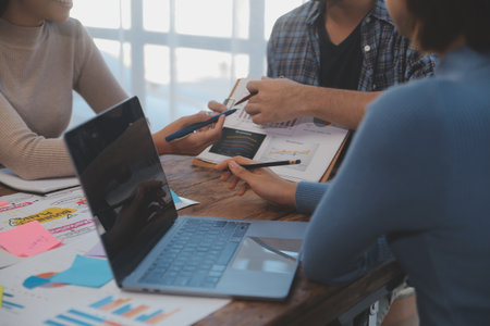 Team of business people working together in the meeting room office, teamwork background charts and...
