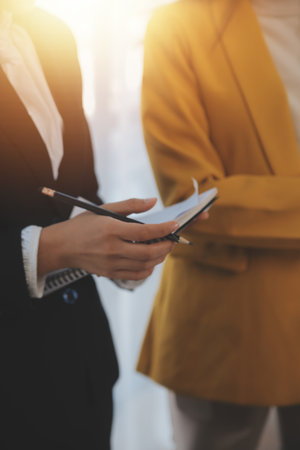 Meeting of business executives discussing analysis of the company's financial situation and business planning with partner collaboration and consultation of strategy.の写真素材