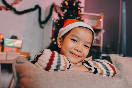christmas, x-mas, winter, happiness concept - dreaming girl in santa helper hatの写真素材