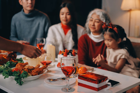 Multi-Generation Family Celebrate Christmas At Home Wearing Santa Hats And Antlers Opening Presentsの写真素材