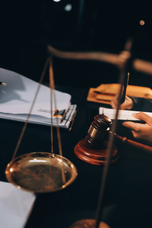Judge gavel with Justice lawyers having team meeting at law firm background. Concepts of Law and...