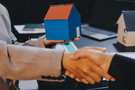 Close up Business people or Real Estate agent explain signing agreement for sale house to client. Property, Insurance, Broker concept.の写真素材