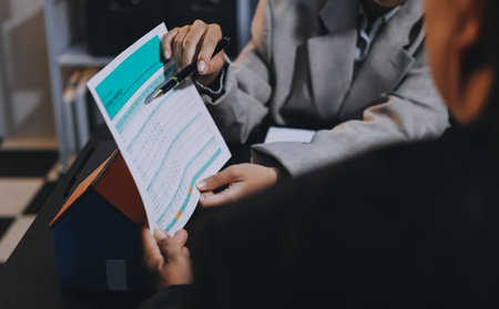 Close up Business people or Real Estate agent explain signing agreement for sale house to client....