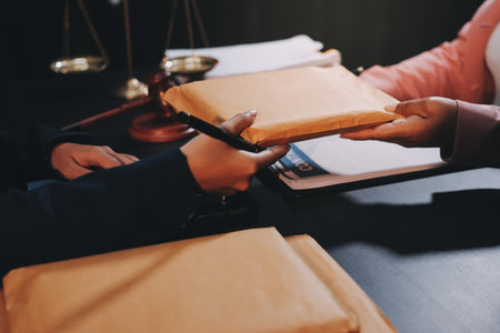 Judge gavel with Justice lawyers having team meeting at law firm background. Concepts of Law and Legal services.の写真素材