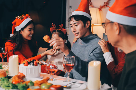 Happy multigeneration family enjoying in opening gifts on Christmas eve at home.の写真素材