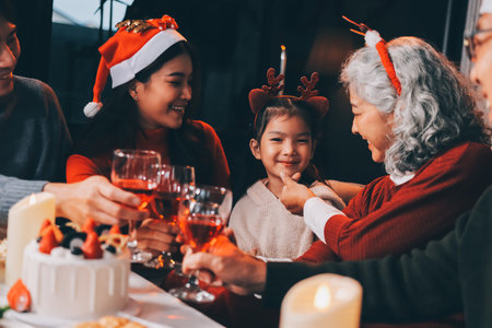 Happy multigeneration family enjoying in opening gifts on Christmas eve at home.の写真素材