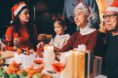 Happy family with gifts celebrating Christmas togetherの写真素材