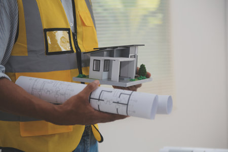 Image of engineer meeting for architectural project. working with partner and engineering tools on workplace vintage tone.の写真素材