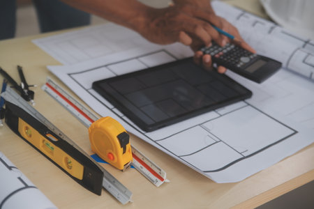 Image of engineer meeting for architectural project. working with partner and engineering tools on...