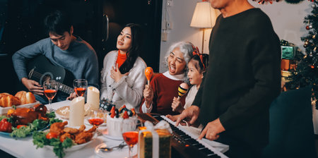 Multi-Generation Family Celebrate Christmas At Home Wearing Santa Hats And Antlers Opening Presentsの写真素材