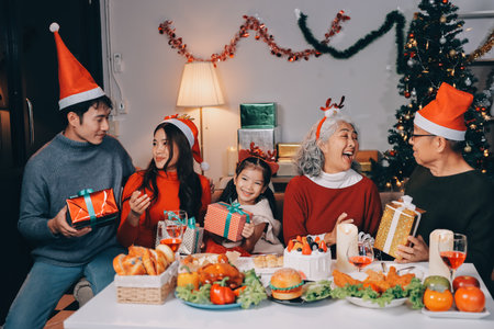 Happy family with gifts celebrating Christmas togetherの写真素材
