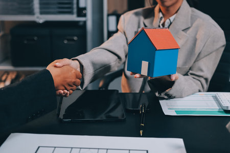 Close up Business people or Real Estate agent explain signing agreement for sale house to client. Property, Insurance, Broker concept.の写真素材