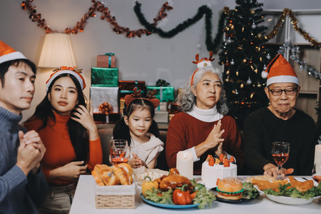 Happy multigeneration family enjoying in opening gifts on Christmas eve at home.の写真素材