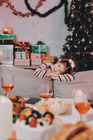 Full size photo of attractive teen girl lying floor gifts dressed green christmas outfit cozy day light home party decoration interior roomの写真素材