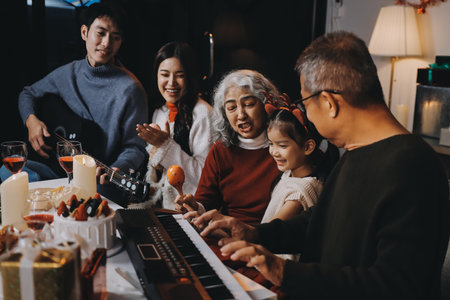 Multi-Generation Family Celebrate Christmas At Home Wearing Santa Hats And Antlers Opening Presentsの写真素材